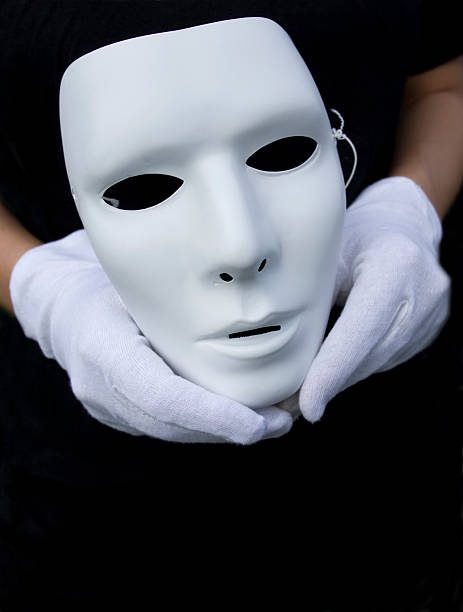 young dramatic comedian holds his maskmime street mask