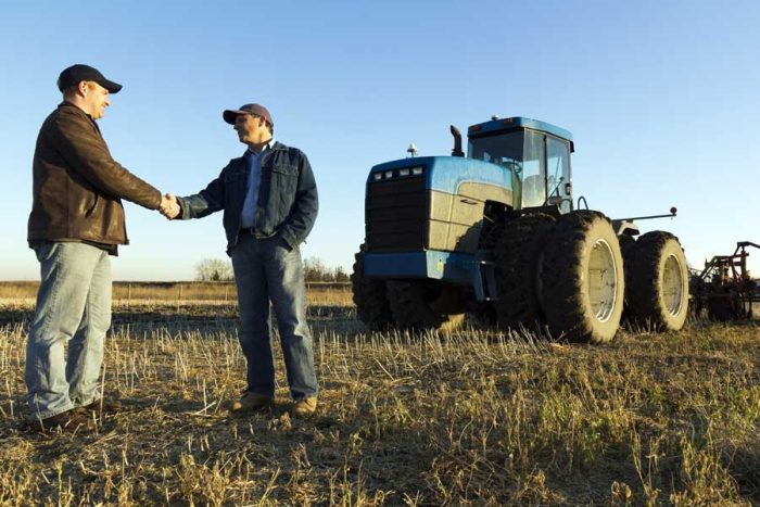 farmer business hand shake RGB istock