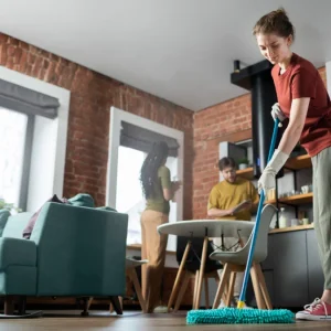 full shot people cleaning room together 945x675.jpg