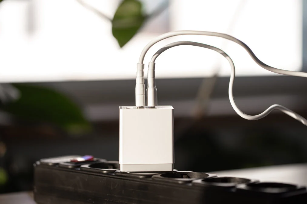 white usb charging gadgets blurred background room closeup 1013x675.jpg