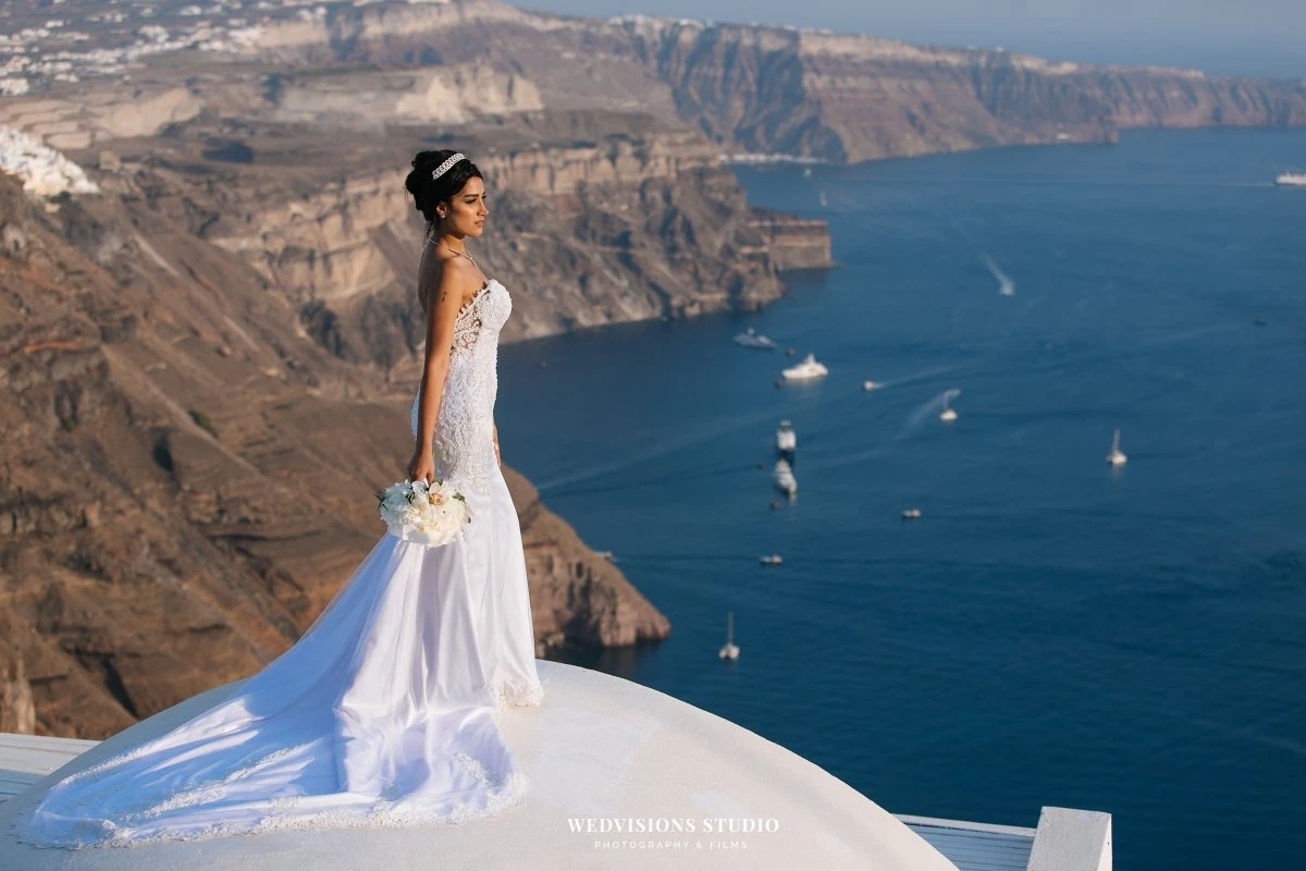 santorini lebanese bride on rooftop overlooking the caldera cliffs wedvisions studio.webp