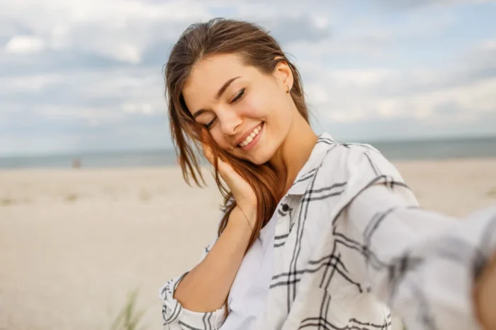 lovely smiling woman making self portrait enjoying holidays near ocean 1013x675.jpg