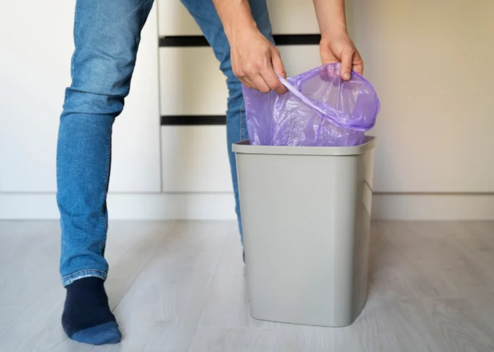 man servant doing chores around house kitchen bin.jpg