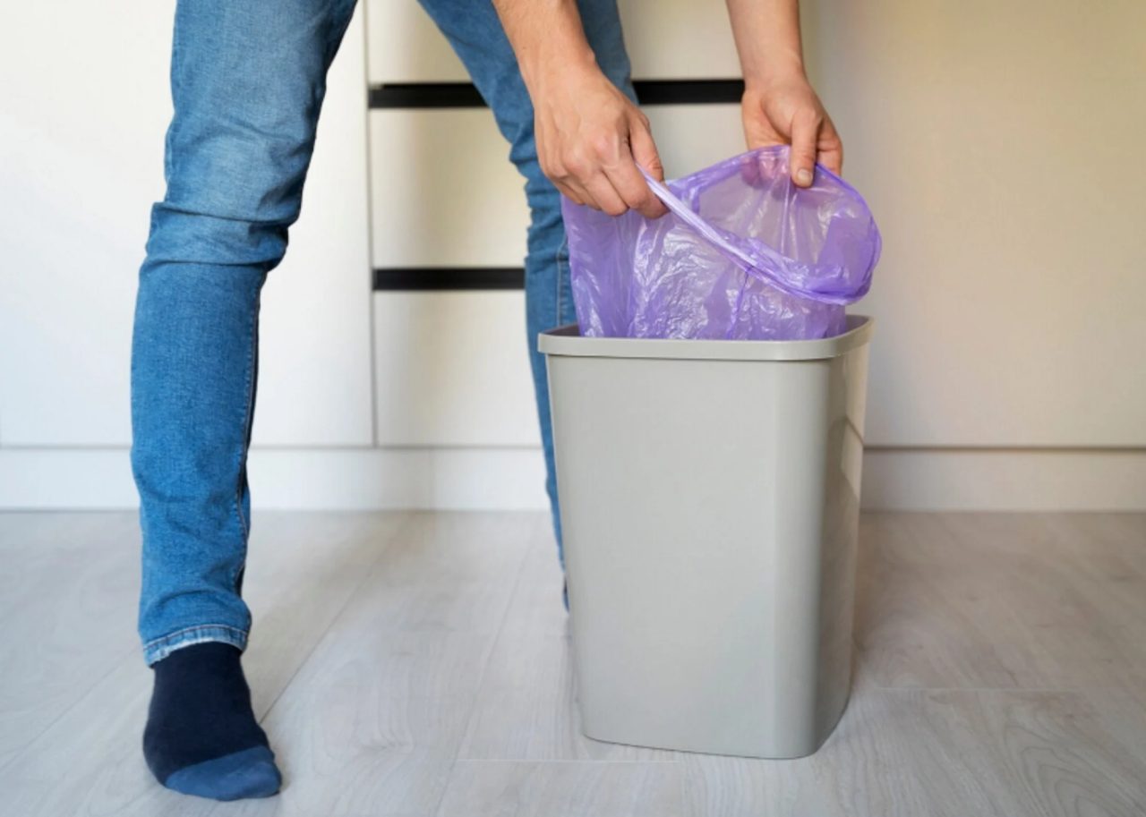man servant doing chores around house kitchen bin.jpg
